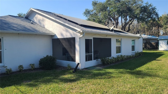 view of side of home featuring a yard and a sunroom