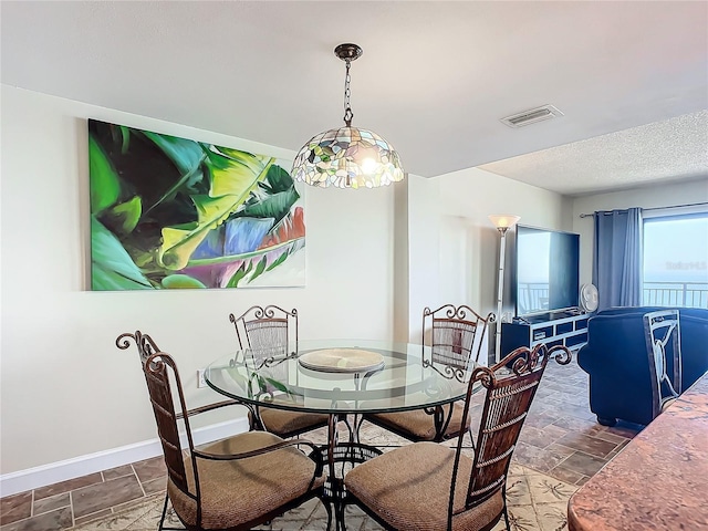 dining space featuring a textured ceiling