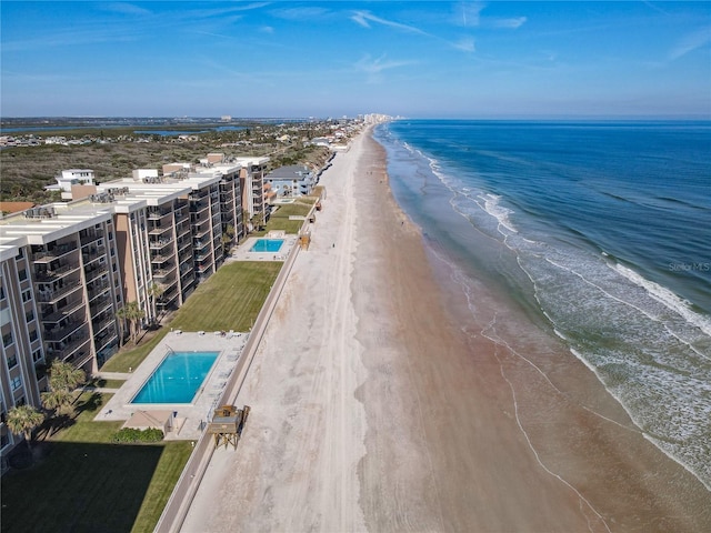 drone / aerial view featuring a water view and a beach view