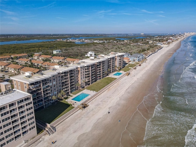 bird's eye view with a water view and a view of the beach