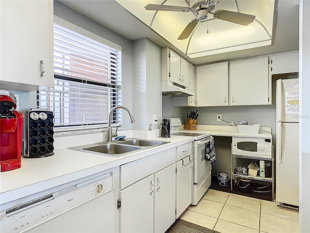 kitchen with white appliances, light tile patterned floors, sink, and white cabinets