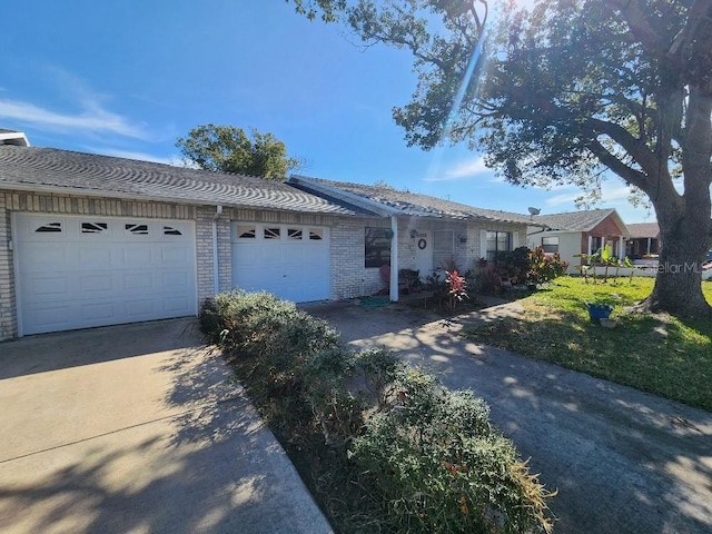 ranch-style house with a garage and a front lawn