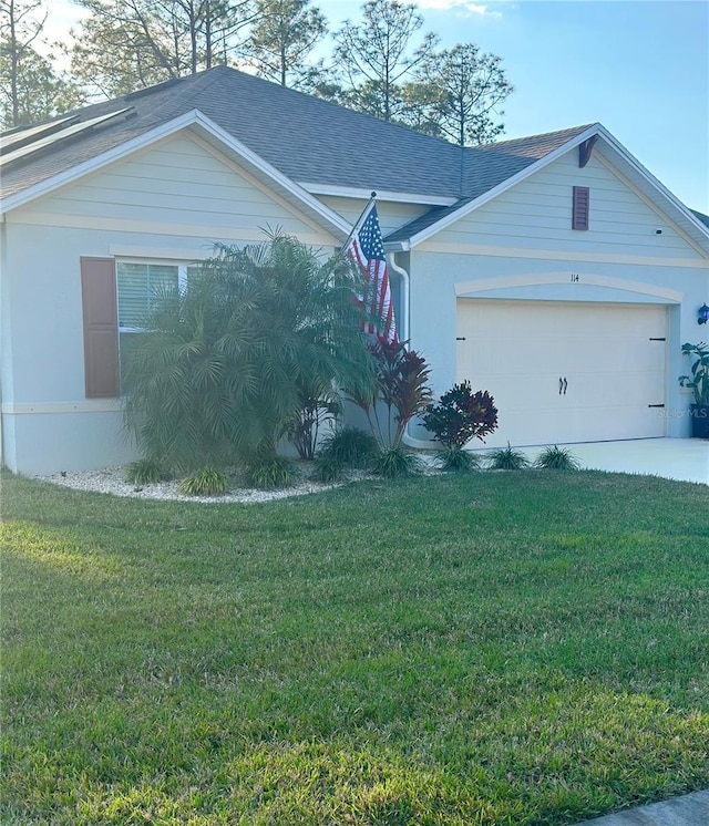 view of front of home with a garage and a front yard