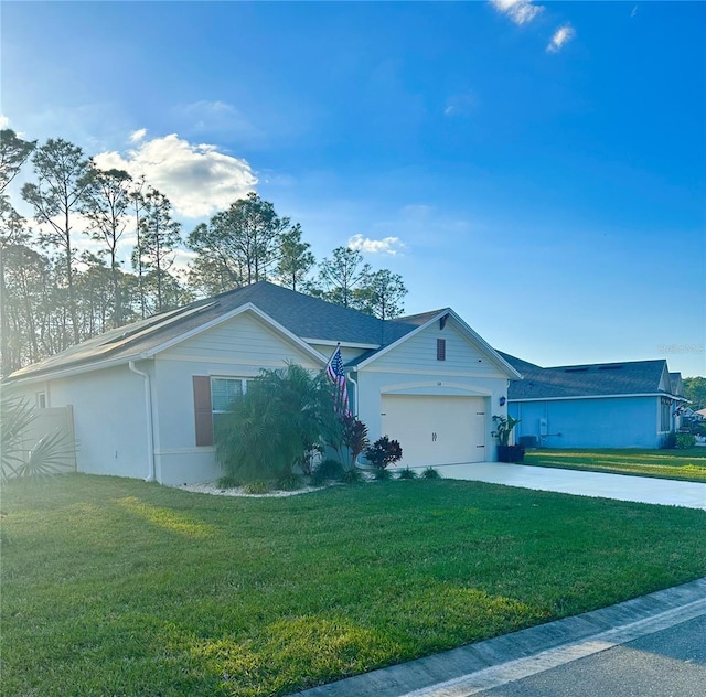 ranch-style home featuring a garage and a front lawn