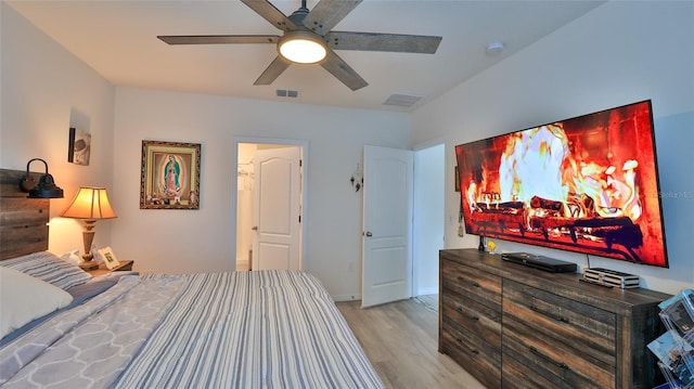 bedroom with ceiling fan and light hardwood / wood-style flooring