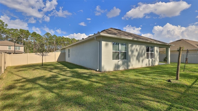 view of side of property with a lawn