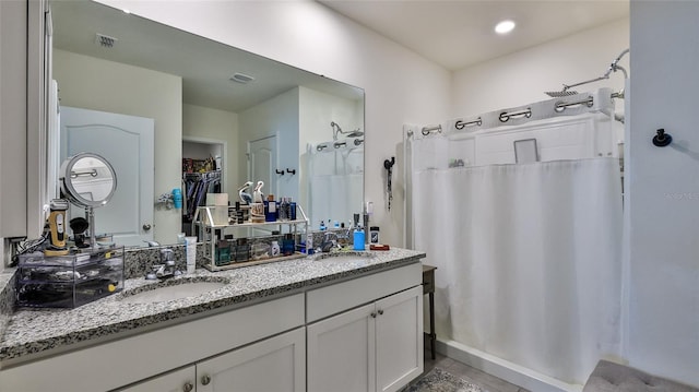 bathroom with vanity and a shower with shower curtain