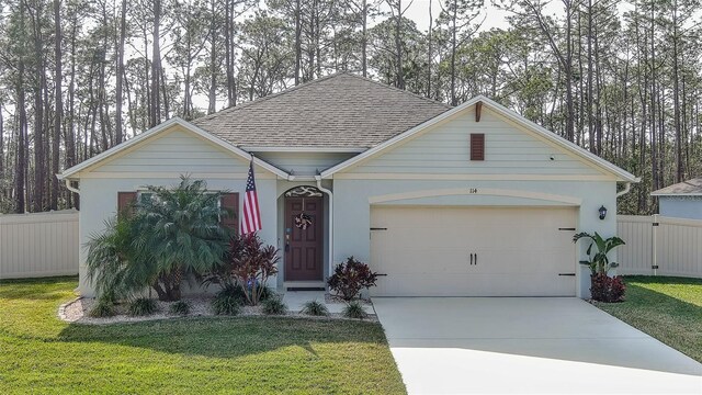 view of front of property featuring a garage and a front lawn