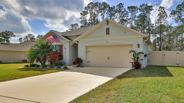 view of front facade with a garage, a front lawn, and central air condition unit