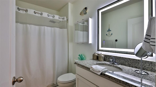 bathroom featuring vanity and toilet