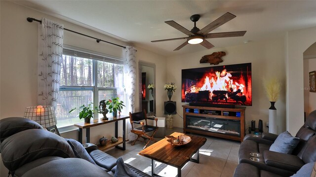 living room featuring light tile patterned flooring and ceiling fan