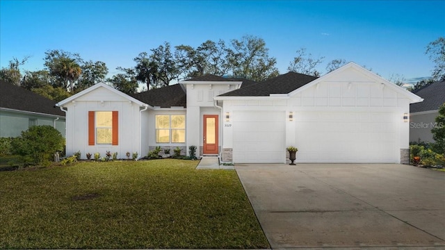 view of front facade with a garage and a front lawn