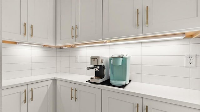 kitchen with backsplash and white cabinets