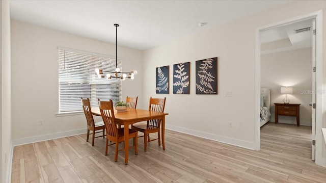 dining space featuring a chandelier and light hardwood / wood-style flooring