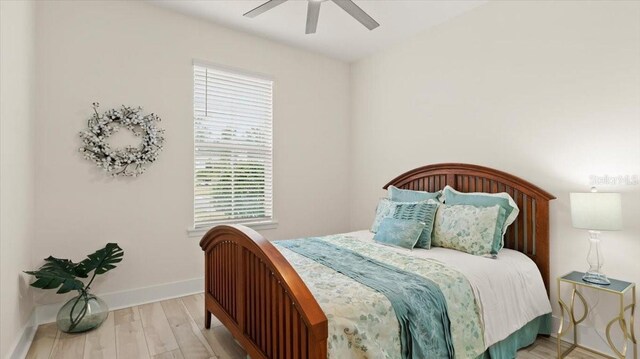 bedroom featuring light hardwood / wood-style flooring and ceiling fan