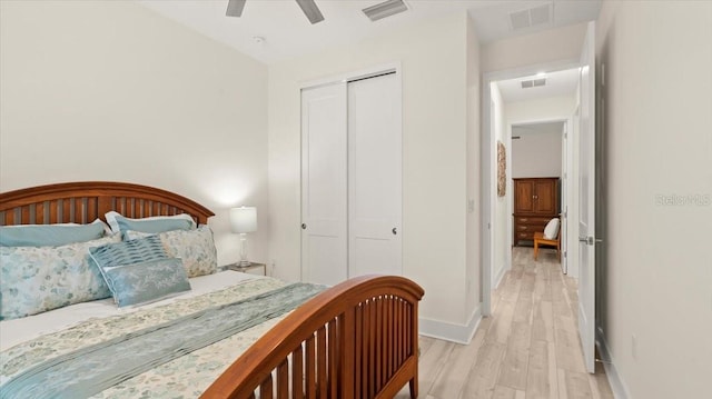 bedroom featuring ceiling fan, light wood-type flooring, and a closet