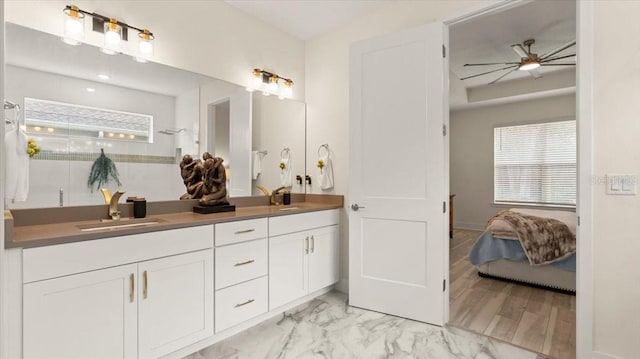 bathroom with vanity, ceiling fan, and walk in shower