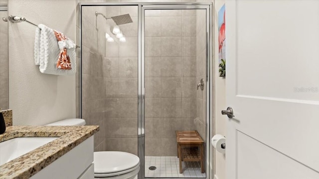 bathroom with vanity, toilet, and walk in shower