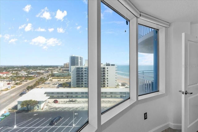 doorway with a water view and a textured ceiling