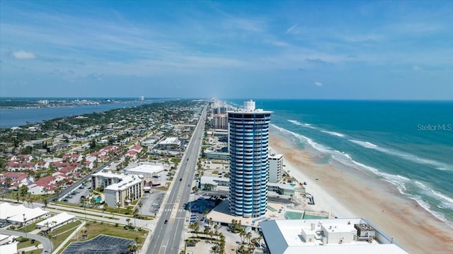 birds eye view of property featuring a beach view and a water view