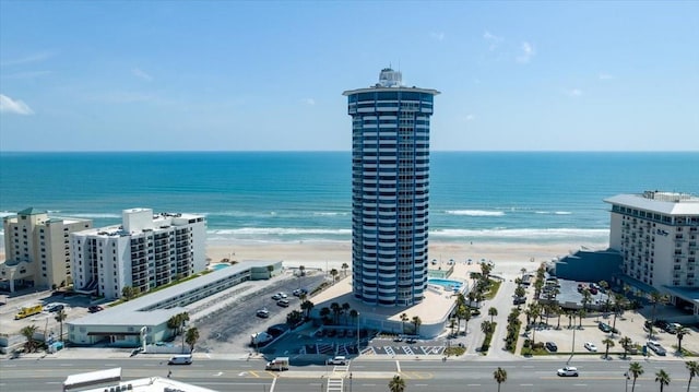 birds eye view of property with a water view and a view of the beach