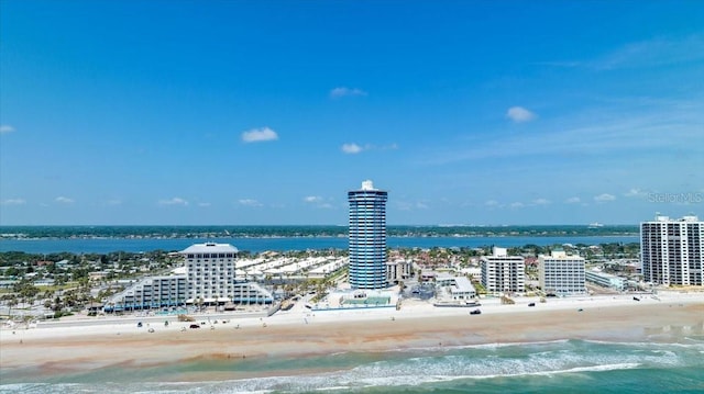 drone / aerial view featuring a beach view and a water view