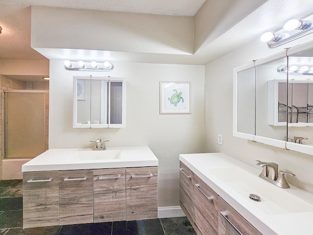 bathroom with vanity, a shower with shower door, and tile patterned floors