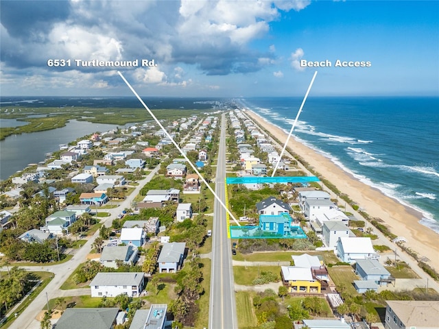 bird's eye view with a water view and a view of the beach