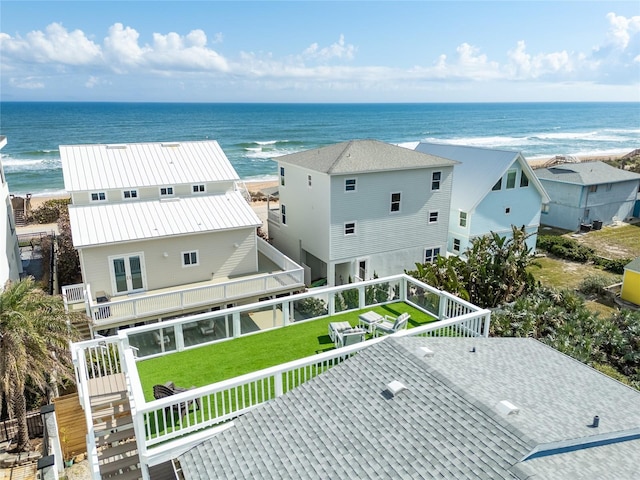 bird's eye view with a water view and a beach view