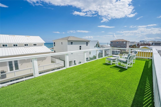 back of property with a lawn and a balcony