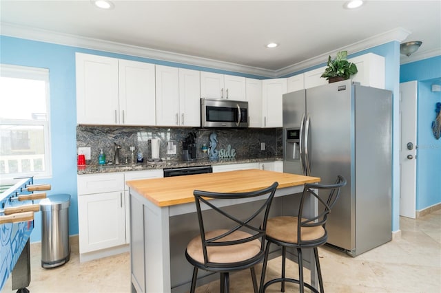 kitchen with white cabinetry, appliances with stainless steel finishes, and a center island