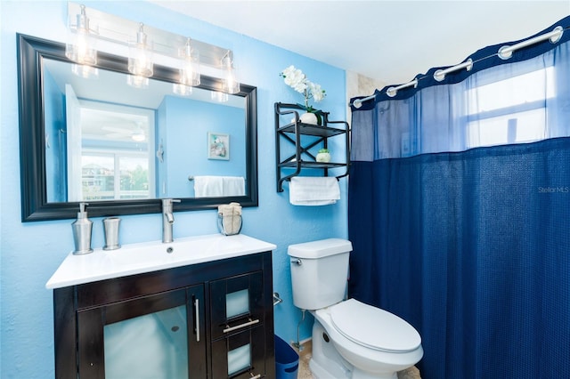 bathroom featuring vanity, a shower with shower curtain, and toilet