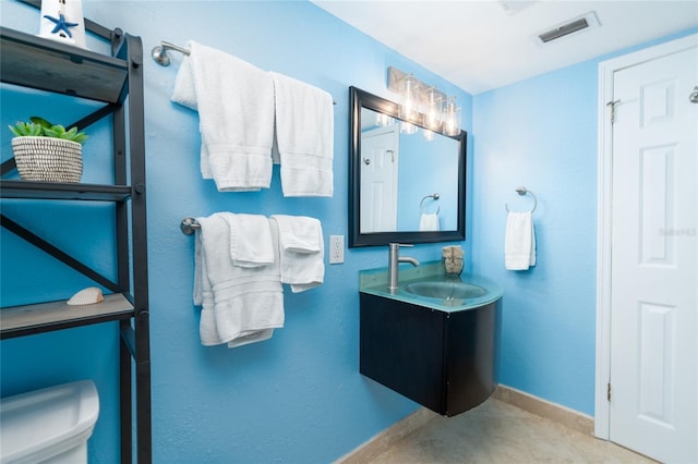 bathroom with vanity and toilet