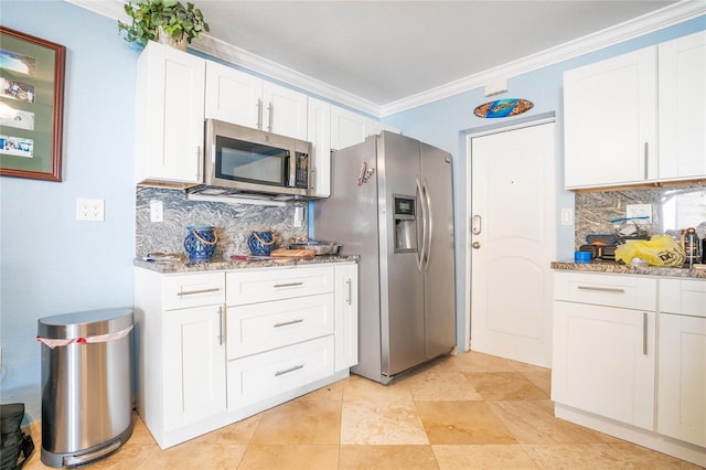 kitchen with white cabinetry, appliances with stainless steel finishes, crown molding, and stone countertops