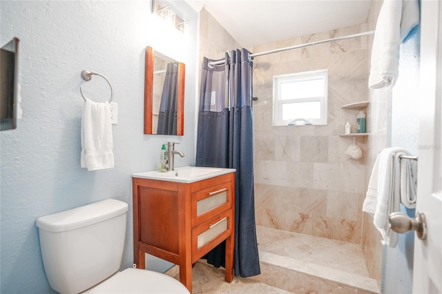 bathroom featuring vanity, toilet, and walk in shower