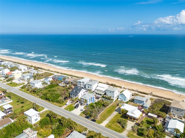 drone / aerial view featuring a beach view and a water view