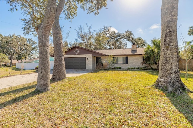 ranch-style house with a garage and a front yard