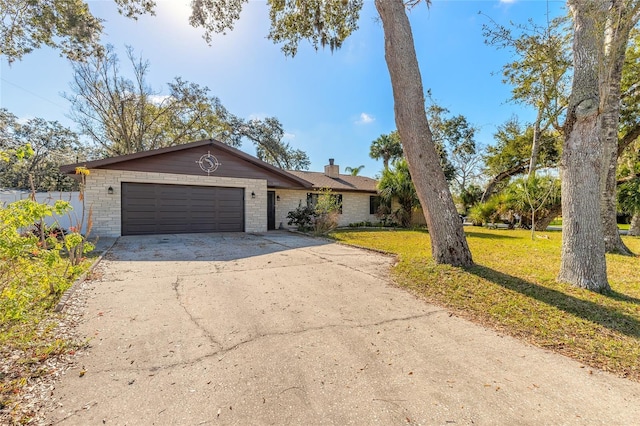 ranch-style home featuring a garage and a front lawn