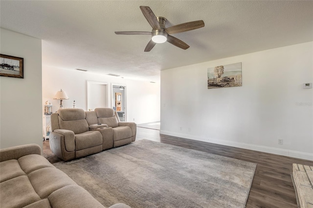 living room with dark hardwood / wood-style flooring and a textured ceiling