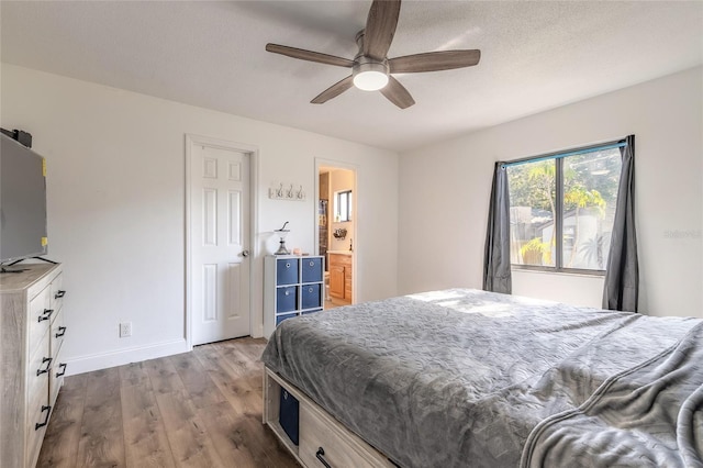 bedroom featuring ceiling fan, hardwood / wood-style flooring, and a textured ceiling