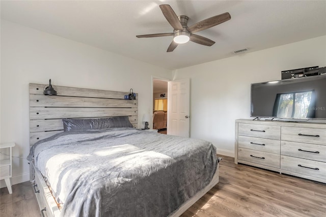 bedroom with ceiling fan and light hardwood / wood-style floors