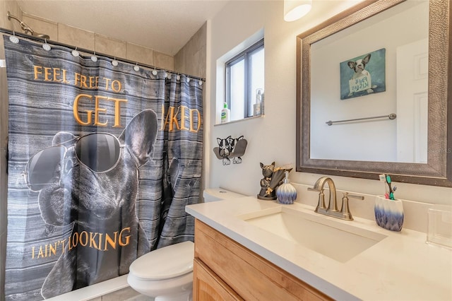 bathroom with vanity, a shower with shower curtain, and toilet