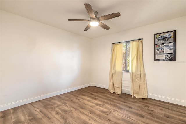 spare room with hardwood / wood-style floors and ceiling fan