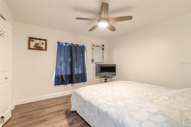 bedroom with ceiling fan and dark hardwood / wood-style flooring