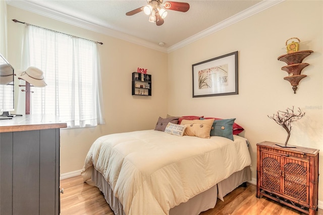 bedroom featuring crown molding, ceiling fan, and light hardwood / wood-style floors