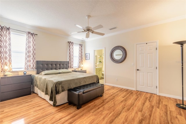 bedroom with crown molding, ensuite bath, light hardwood / wood-style flooring, a textured ceiling, and ceiling fan