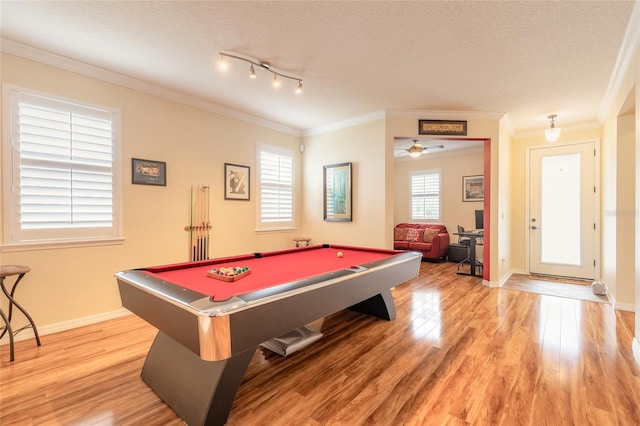 rec room with hardwood / wood-style flooring, crown molding, and a textured ceiling