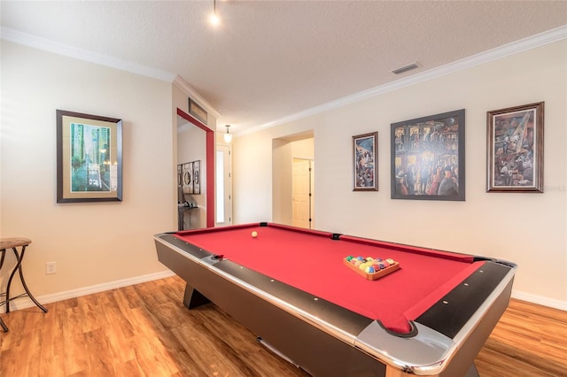 game room featuring billiards, wood-type flooring, ornamental molding, and a textured ceiling