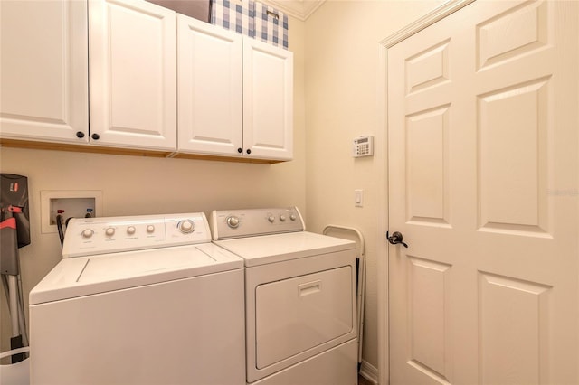 washroom featuring separate washer and dryer and cabinets