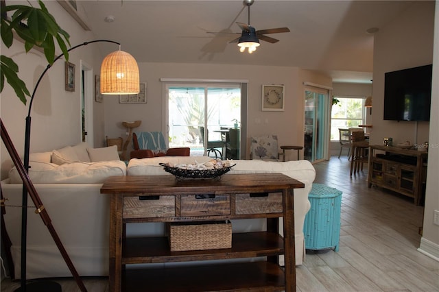 living room with ceiling fan and light wood-type flooring